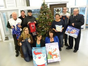 Intelligencer file photo 
Lisa Triemstra, Adopt a Child co-ordinator, Jane and Shea Robson, Tammi Caldwell, Debbie Webb, Christian Minaker, Kristin Ferguson of Trenton Glass & Window Adopt a Child Centre, Rick Kevan of Rock 107 and Lt. Rob Hardy, Pastor at the Salvation Army Community Church in Trenton, are asking for donations for the Quinte West Adopt a Child program. Triemstra said the program is at risk of not being able to help all families who have registered this year.