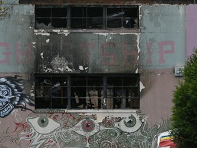 The front of The Ghost Ship warehouse damaged from a deadly fire is seen Wednesday, Dec. 7, 2016, in Oakland, Calif. The fire that killed 36 people during a party at an Oakland warehouse started on the ground floor and quickly raged, with smoke billowing into the second level and trapping victims whose only escape route was through the flames, federal investigators said Wednesday. (AP Photo/Eric Risberg)