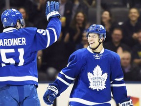 Toronto Maple Leafs' Jake Gardiner celebrates his goal against the Carolina Hurricanes with teammate Connor Carrick (8) during first period NHL hockey action in Toronto on November 22, 2016. (THE CANADIAN PRESS/Frank Gunn )