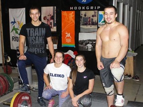 From left, Noah Santavy, Alana Santavy, Olivia Freer and Boady Santavy are pictured inside their training facility below We Are Fitness on Thursday December 8, 2016 in Point Edward, Ont. The four local Olympic-style weightlifters have qualified for next month's junior Canadian championships based partly through their performances at provincials this past Saturday in Oakville. (Terry Bridge/Sarnia Observer)