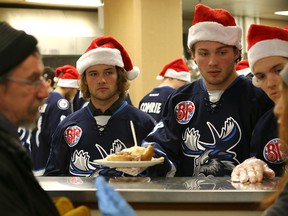Chase De Leo, Brendan Lemieux and Jack Roslovic (from left) of the Manitoba Moose help deliver a meal at Siloam Mission last Wednesday. (Kevin King/Winnipeg Sun)