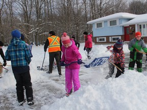 A group of students at Harrisfield Public School in Ingersoll took to the streets with their shovels on Friday, Dec. 9, 2016. Buses were cancelled, and many pupils were at home celebrating a snow day, but more than a dozen of their peers decided to shovel driveways for older adults and those in need. (MEGAN STACEY/Sentinel-Review)