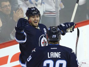 Mark Scheifele (left) celebrates his second period goal against the New York Rangers with right winger Patrik Laine on Thursday night. (Brian Donogh/Winnipeg Sun)