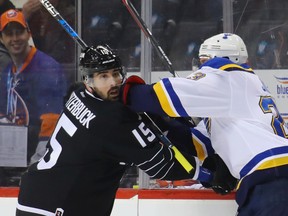 Patrik Berglund of the St. Louis Blues hits Cal Clutterbuck of the New York Islanders during the first period at the Barclays Center on Dec. 8, 2016 in New York City. (Bruce Bennett/Getty Images)