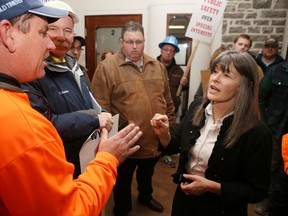 Robert Kelly of the International Brotherhood of Electrical Workers Local 115 speaks to Kingston and the Islands MPP Sophie Kiwala during a protest against Bill 70 in Kingston on Friday. (Elliot Ferguson/The Whig-Standard)