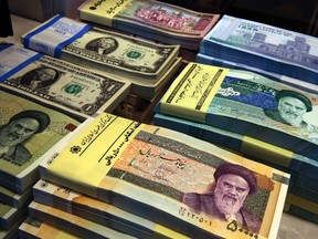 In this April 4, 2015 photo, Iranian and U.S. banknotes are on display at a currency exchange shop in downtown Tehran, Iran. (AP Photo/Vahid Salemi)