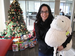 Brandi Timpson, supervisor of enforcement for the City of Kingston, holds one of the toys donated to the Toys for Tickets campaign, where people with parking tickets can donate a toy of equal or greater value instead of paying cash. (Michael Lea/The Whig-Standard)