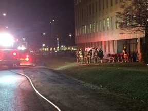 Kingston Fire & Rescue firefighters respond to a fire inside the Ontario government building on Princess Street across from the Kingston Centre. (Steph Crosier/The Whig-Standard)