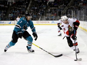 Senators winger Bobby Ryan skates past Paul Martin of the San Jose Sharks on Dec. 7. (Getty Images)