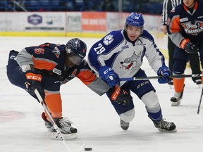 Darian Pilon, right, of the Sudbury Wolves, and Jalen Smereck, of the Flint Firebirds, fight for possession of the puck during OHL action at the Sudbury Community Arena in Sudbury, Ont. on Friday December 9, 2016. John Lappa/Sudbury Star/Postmedia Network