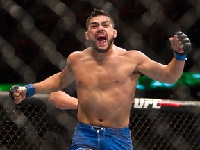 Kelvin Gastelum celebrates after defeating Jake Ellenberger, both from the United States, in a UFC 180 bout in Mexico City on Nov. 15, 2014. (AP Photo/Christian Palma)