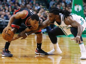 Toronto Raptors' Kyle Lowry keeps the ball away from Boston Celtics' Jae Crowder during the second half of an NBA game in Boston on Dec. 9, 2016. (AP Photo/Winslow Townson)