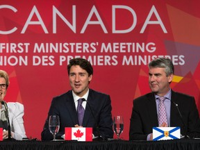 Canadian Prime Minister Justin Trudeau and Ontario Premier Kathleen Wynne (left) share a laugh as Nova Scotia Premier Stephen McNeil (right) looks on during the closing news conference at the First Ministers Meeting in Ottawa, Friday December 9, 2016. (THE CANADIAN PRESS/Adrian Wyld)