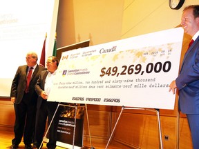 Laurentian University President Dominic Giroux looks on as Paul Lefebvre, MP for Sudbury, and Marc Serré, MP for Nickel Belt, unveil a cheque for $49.269 million in funding for the Metal Earth project initiative at Laurentian University on Tuesday, Sept. 6. Gino Donato/Sudbury Star
