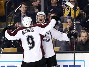 Avalanche's John Mitchell celebrates his first point of the season, a goal, on Thursday in Boston with new linemate Matt Duchene. (Getty Images)