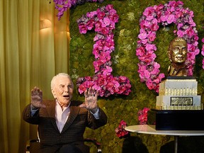 Kirk Douglas acknowledges applause from the crowd at his 100th birthday party at the Beverly Hills Hotel on Friday, Dec. 9. 2016, in Beverly Hills, Calif. (Photo by Chris Pizzello/Invision/AP)
