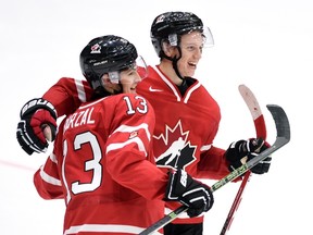 Canada's Mathew Barzal celebrates his team's win over Switzerland with teammate Thomas Chabot in preliminary round hockey action at the IIHF World Junior Championship in Helsinki, Finland on Dec. 29, 2015. (THE CANADIAN PRESS/Sean Kilpatrick)