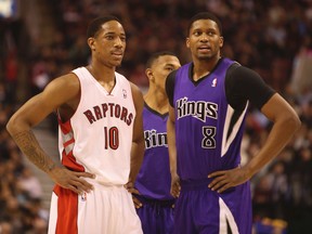 Old teammates DeMar DeRozan and Kings Rudy Gay chat at centre court during a Raptors-Kings game in Toronto on March 8, 2014. (Jack Boland/Toronto Sun)