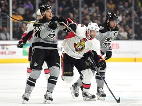 Tom Pyatt of the Senators gets tangled up with Trevor Lewis (left) and Anze Kopitar of the Los Angeles Kings on Dec. 10. (Getty Images)