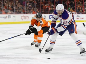 Leon Draisaitl #29 of the Edmonton Oilers moves the puck in front of Brayden Schenn #10 of the Philadelphia Flyers before scoring a first period goal at Wells Fargo Center on December 8, 2016 in Philadelphia, Pennsylvania.