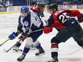 David Levin, left, of the Sudbury Wolves, is pushed off the puck by Julius Nattinen, of the Windsor Spitfires, during OHL action at the Sudbury Community Arena in Sudbury, Ont. on Saturday December 10, 2016. John Lappa/Sudbury Star/Postmedia Network