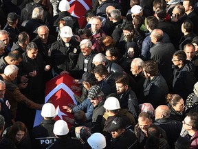 People gather to attend a memorial in Istanbul, Sunday, Dec. 11, 2016, for police officers killed outside the Besiktas football club stadium Vodafone Arena late Saturday.  (AP Photo)