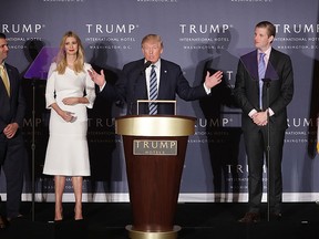 Donald Trump (C) delivers remarks with his children (L-R) Donald Trump Jr., Ivanka Trump and Eric Trump during the grand opening ceremony of the Trump International Hotel in Washington, D.C. in this  Oct. 26, 2016 file photo.  (Photo by Chip Somodevilla/Getty Images)