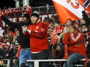 Toronto FC fans react after their soccer club lost to the Seattle Sounders during penalty kicks in the MLS Cup soccer final action in Toronto on Saturday. (The Canadian Press)