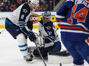 Edmonton's Jordan Eberle (14) is stopped by Winnipeg goaltender Connor Hellebuyck (37) during the second period of a NHL game between the Edmonton Oilers and the Winnipeg Jets at Rogers Place in Edmonton, Alberta on Sunday, December 11, 2016. Ian Kucerak / Postmedia