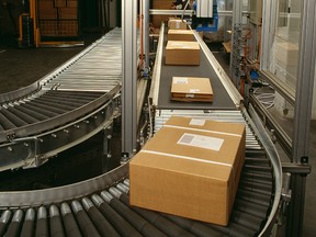 Postal boxes are pictured on a conveyor belt in this file photo. (clu/Getty Images)