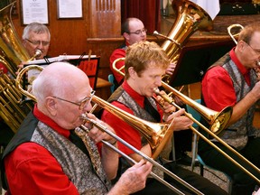 The Mitchell Legion Band performed at its annual Christmas Concert last Tuesday, Dec. 6 at the Crystal Palace. Art Heimpel (left), Jon Michael Falconer and Andrew Checinski on trombones play ‘Joy to the World’ along with the rest of the band. GALEN SIMMONS MITCHELL ADVOCATE