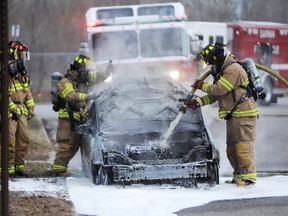 Sarnia firefighters work to extinguish a car fire on Water Street behind the Sarnia police station in this Jan. 18, 2013 file photo. A service spokesperson says a new fire truck with enhanced foam capabilities will be on the way in 2017. Tyler Kula/Sarnia Observer/Postmedia Network