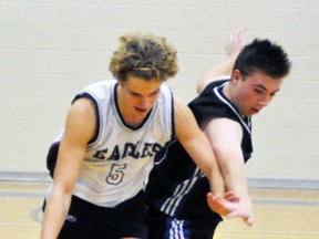 Owen Reitsma (5) of St. Anne’s battles Joey McIntosh of the Mitchell District High School (MDHS) during Huron-Perth senior boys basketball action last Wednesday, Dec. 7 at MDHS. ANDY BADER MITCHELL ADVOCATE