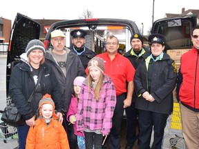 Auxiliary Ontario Provincial Police (OPP) officers and Mitchell Salvation Army Food Bank manager Barry Clarke were in the Walkom’s valu-mart parking lot Dec. 3 collecting donations of non-perishable food items for the OPP's annual Stuff the Cruiser Food Drive. Patrick Walker, the owner of Ontario Beer Kegs Ltd. and his family also stopped by to donate several shopping carts full of food purchased with a portion of the proceeds he made from this year's batch of Toy Soldier Stout. Overall, 10 shopping carts full of food were collected, which filled the Perth County OPP prisoner van stationed outside. Pictured from left, Angela, Byron, Patrick, Ayla and Aarya Walker, OPP auxiliary Sgt. Wesson, Steve Walkom of valu-mart, OPP auxiliary Const. Halls, OPP auxiliary Const. Leslie and Barry Clarke. GALEN SIMMONS MITCHELL ADVOCATE