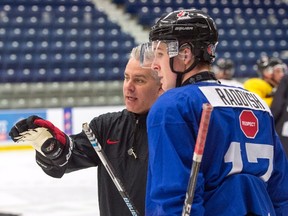 Canada's head coach Dominique Ducharme goes over a drill with Taylor Raddysh as the world junior selection camp opens in Boisbriand, Que., on Sunday, Dec. 11, 2016. (Ryan Remiorz/The Canadian Press)