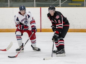 Port Hope Panthers veteran defenceman Cam McGill, left, seen here playing against the Gananoque Islanders last season, says this year's undefeated edition of the Panthers has become "a tight-knit group of guys." (The Whig-Standard)