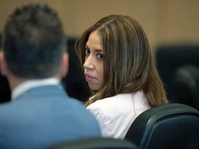 Dalia Dippolito looks at defence attorney Brian Claypool during her murder-for-hire retrial at the Palm Beach county courthouse in West Palm Beach, Fla., on Friday, Dec. 9, 2016. (Allen Eyestone /Palm Beach Post via AP, Pool)