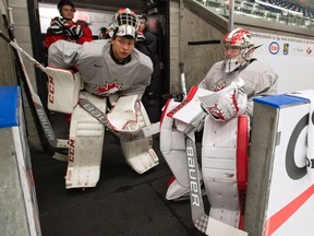 Canada's goaltenders Michael McNiven, left, and Carter Hart wait to hit the ice as the world junior selection camp opens, in Boisbriand, Que., on Sunday, December 11, 2016. THE CANADIAN PRESS/Ryan Remiorz