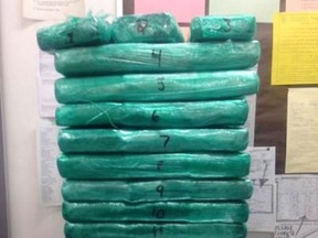 This undated photo released by the Los Angeles Airport Police shows multiple packages of cocaine wrapped in green cellophane that was apprehended at Los Angeles International Airport. JetBlue flight attendant accused of trying to sneak a suitcase full of cocaine through Los Angeles International Airport and making a dramatic dash to escape says she might not have been sure what was in her bag, a spokesman for her said Thursday, March 24, 2016, as prosecutors suggested she had smuggled before. (Los Angeles Airport Police via AP)