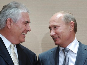 In this Aug. 30, 2011, file photo, Russian Prime Minister Vladimir Putin, right, and Rex Tillerson, ExxonMobil's chief executive smile during a signing ceremony in the Black Sea resort of Sochi, Russia. President-elect Donald Trump selected ExxonMobil CEO Rex Tillerson to lead the State Department on Monday, Dec. 12, 2016. (Alexei Druzhinin/RIA Novosti via AP, Pool)