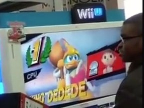 A Best Buy worker offers a free Nintendo WiiU to a customer (YouTube screen grab)