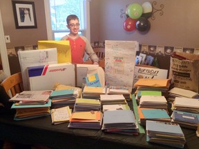 Norwich resident 13-year-old Andon Gatti surverys the almost 1,400 cards and packages he received for his 13th birthday on December 12. Submitted photo