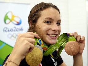 Penny Oleksiak of Team Canada shows off her medals during the Rio Olympics in Rio de Janeiro, Brazil on Aug. 14, 2016. (Dave Abel/Toronto Sun/Postmedia Network)