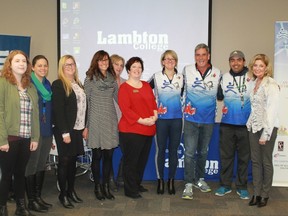 Joe Roberts (third from the right) and his Push For Change team joined Lambton College President Judith Morris (far right), staff and students at an event at Lambton College on Monday, Nov. 5. Roberts is pushing a shopping cart across Canada to raise awareness about youth homelessness. 
CARL HNATYSHYN/SARNIA THIS WEEK
