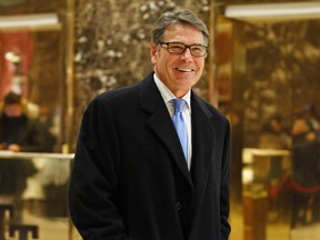 Former Texas Gov. Rick Perry smiles as he leaves Trump Tower in New York on Dec. 12, 2016. Perry is President-elect Donald Trump’s choice to become energy secretary, two people with knowledge of the decision say. (AP Photo/Kathy Willens, File)