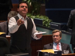 Mayor John Tory listens to Councillor Giorgio Mammoliti at city council's road tolls debate at City Hall on Dec. 13, 2016. (Craig Robertson/Toronto Sun)