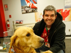 Stephen Zager at Pearson Airport with the dog he is adopting that just arrived from Turkey part of a rescue campaign to save golden retrievers on Dec 13, 2016. (Michael Peake/Toronto Sun)