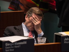 Mayor John Tory listens during the day-long road toll debate at city council on Dec. 13, 2016. (Craig Robertson/Toronto Sun)