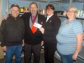 The Knights of Columbus of St. Michael's Dresden Council #9473 donated $1,000 to Salvation Army's Kettle campaign. Making the donation from the Knights of Columbus are, from left, Len Lozon and Lennard St. Laurent, to Salvation Army's Stephanie Watkinson and Hayley Smith. The Salvation Army of Chatham-Kent has set a local goal of $450,000 for this year's Christmas campaign.