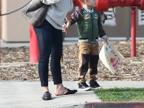 Hilary Duff has fun with her son Luca Comrie at a demonstration by the Los Angeles Fire Department Studio City station in Los Angeles on Dec. 5, 2016. (WENN.com)